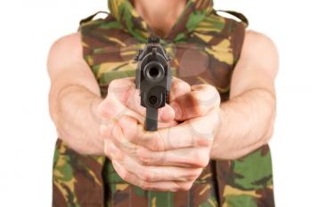 Soldier in camouflage vest is holding a gun, isolated