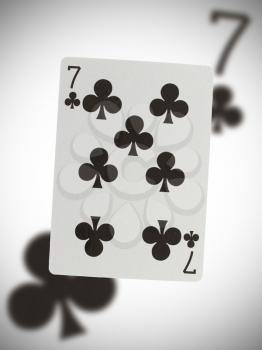 Playing card with a blurry background, seven