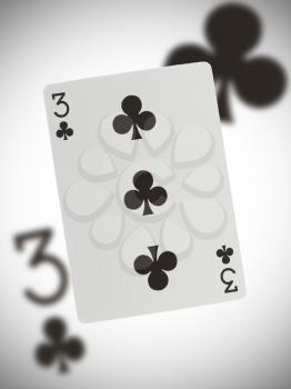 Playing card with a blurry background, three