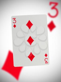 Playing card with a blurry background, three
