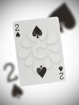 Playing card with a blurry background, two of spades