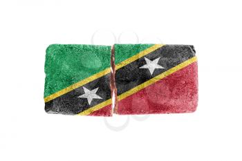 Rough broken brick, isolated on white background, flag of Saint Kitts and Nevis