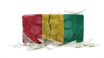 Brick with broken glass, violence concept, flag of Guinea