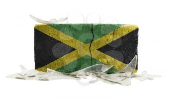 Brick with broken glass, violence concept, flag of Jamaica