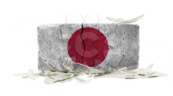 Brick with broken glass, violence concept, flag of Japan