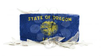 Brick with broken glass, violence concept, flag of Oregon