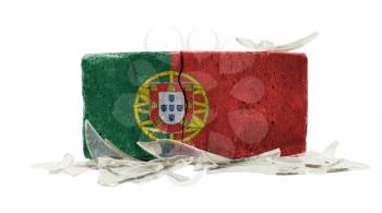 Brick with broken glass, violence concept, flag of Portugal