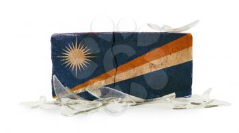 Brick with broken glass, violence concept, flag of The Marshall Islands