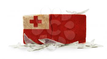 Brick with broken glass, violence concept, flag of Tonga