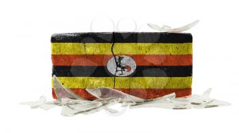 Brick with broken glass, violence concept, flag of Uganda