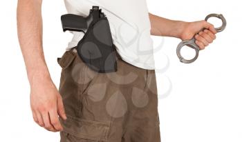 Close-up of a man with a gun and handcuffs, isolated on white