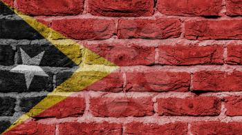 Very old brick wall texture, flag of East Timor