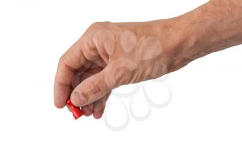 Hand holding a red pawn, isolated on white