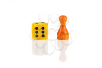 One orange pawn and a yellow dice isolated on a white background