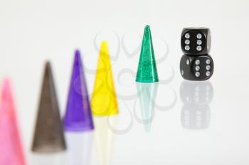 Different colored pawns isolated on a white background, selective focus