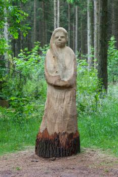 Wooden statue of a woman made from a sigle tree
