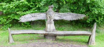 Wood craft of a eagle on top of a bench