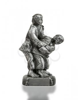 Very old trophy in the shape of two man, judo, isolated on white