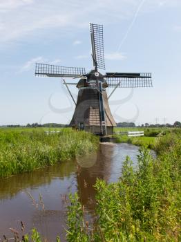 Traditional old dutch windmill in a summer landscape