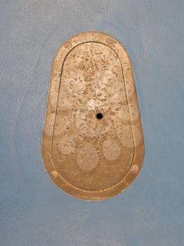 Cast iron manhole in an old school gym