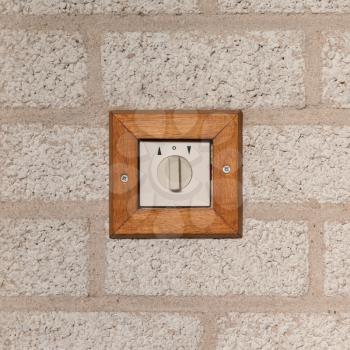 Old switch on a stone wall, isolated