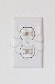 Close-up of an obsolete light-switches on a white wall