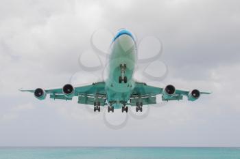 ST MARTIN, ANTILLES - JULY 19, 2013: Boeing 747 aircraft in is landing at Princess Juliana International Airport in Netherlands Antilles in July 19, 2013 in St Martin.