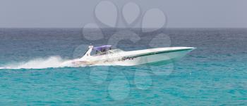 ST MARTIN - ANTILLES, JULY 19, 2013 - Speedboat with tourist on the Caribbean sea on July 19, 2013. Nearly 500.000 tourists visit St Martin every year, much for a isle with 75.000 inhabitants. ST MART
