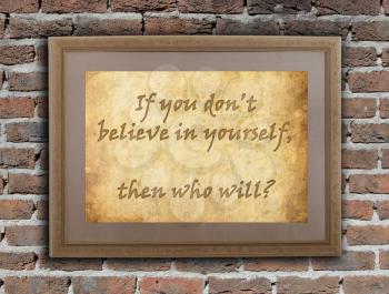 Old wooden frame with written text on an old wall - Believe in yourself