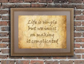Old wooden frame with written text on an old wall - Life is simple