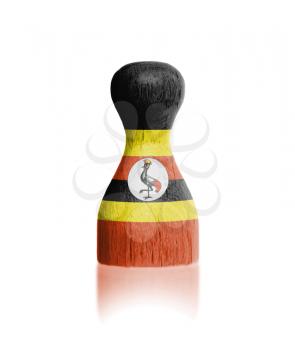 Wooden pawn with a painting of a flag, Uganda