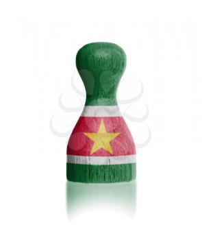 Wooden pawn with a painting of a flag, Suriname