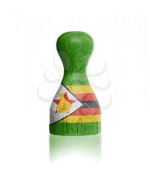 Wooden pawn with a painting of a flag, Zimbabwe