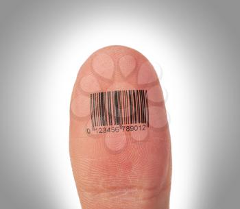 Macro view of a thumb finger over a white background, barcode