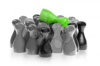 Green pawn is crowdsurfing over a collection of different colors of pawns