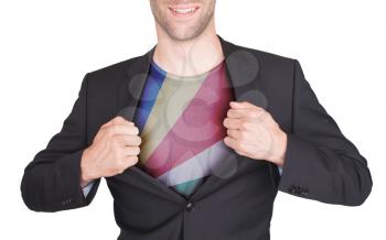 Businessman opening suit to reveal shirt with flag, Seychelles
