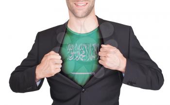 Businessman opening suit to reveal shirt with flag, Saudi Arabia