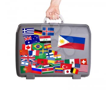 Used plastic suitcase with lots of small stickers, large sticker of the Philippines