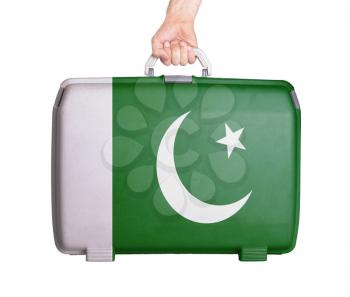 Used plastic suitcase with stains and scratches, printed with flag, Pakistan