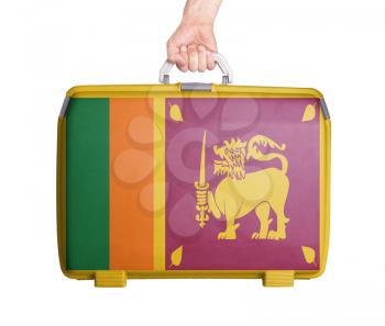 Used plastic suitcase with stains and scratches, printed with flag, Sri Lanka