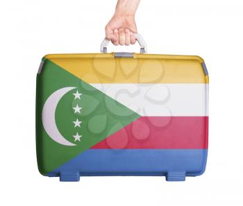 Used plastic suitcase with stains and scratches, printed with flag, Comoros
