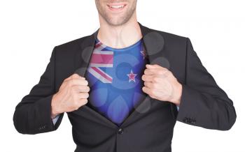 Businessman opening suit to reveal shirt with flag, New Zealand