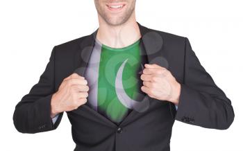 Businessman opening suit to reveal shirt with flag, Pakistan