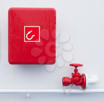 Red handled firehose outlet and a box with a firehose in it