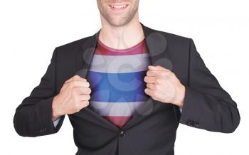 Businessman opening suit to reveal shirt with flag, Thailand