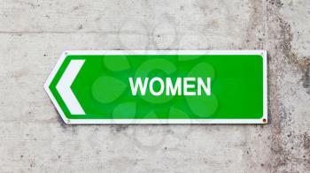 Green sign on a concrete wall - Women