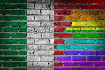 Dark brick wall texture - coutry flag and rainbow flag painted on wall - Italy