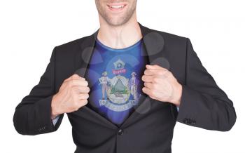 Businessman opening suit to reveal shirt with state flag (USA), Maine