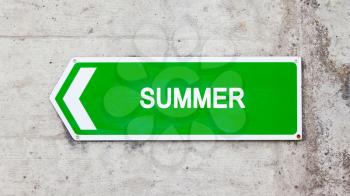 Green sign on a concrete wall - Summer