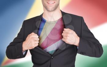 Businessman opening suit to reveal shirt with flag, Seychelles
